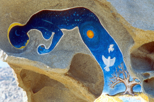 Woman Made of Cosmos — carved and painted stone on the cliffs of Tinos Island, Greece